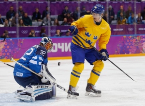 Finland goalkeeper Kari Lehtonen blocks a shot off a rebound by Sweden forward Nicklas Backstrom during the first period of a men's semifinal ice hockey game at the 2014 Winter Olympics, Friday, Feb. 21, 2014, in Sochi, Russia. (AP Photo/Petr David Josek)