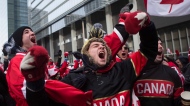 Hockey fans celebrate as Chris Kunitz scores Canada's third goal in the Olympic Hockey final in Toronto's Maple Leaf Square on Sunday, February 23, 2014. Canada beat Sweden 3-0 to win the gold medal. THE CANADIAN PRESS/Chris Young