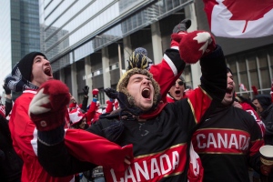 Hockey fans celebrate as Chris Kunitz scores Canada's third goal in the Olympic Hockey final in Toronto's Maple Leaf Square on Sunday, February 23, 2014. Canada beat Sweden 3-0 to win the gold medal. THE CANADIAN PRESS/Chris Young