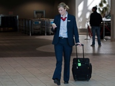 An Air Canada flight attendant walks through the terminal at the Halifax airport on Tuesday, Sept. 20, 2011. About 6,800 of the airline's flight attendants represented by CUPE have been without a contract since March 31st. They gave strike notice and are threatening to walk off the job mid week if their demands aren't met. THE CANADIAN PRESS/Andrew Vaughan