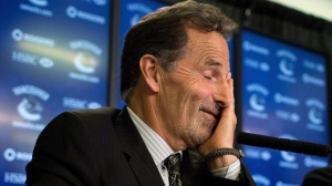 Vancouver Canucks' head coach John Tortorella laughs and rubs his face in response to a question during a news conference after he was hired by the NHL hockey team in Vancouver, B.C., on Tuesday June 25, 2013. (The Canadian Press/Darryl Dyck)