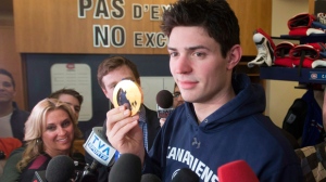 Montreal Canadiens and Team Canada goaltender Carey Price shows his gold medal to the media at the team's practice facility Monday, Feb. 24, 2014 in Brossard, Que. (The Canadian Press/Ryan Remiorz)