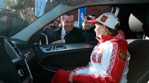 Russian Prime Minister Dmitry Medvedev, rear, speaks with Russian Olympic champion in figure skating Julia Lipnitskaia, sitting in her new Mercedes-Benz in Red Square in Moscow, Thursday, Feb. 27, 2014. (AP Photo/RIA-Novosti, Yekaterina Shtukina, Government Press Service)