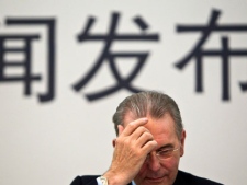 Jacques Rogge, president of the International Olympic Committee, rubs his forehead during a press conference in Beijing, China, Friday, Sept. 23, 2011. Rogge on Friday welcomed an investigation by amateur boxing's governing body into allegations that millions of dollars have been paid to guarantee Azerbaijan two gold medals in the ring at next year's London Olympics. (AP Photo/Alexander F. Yuan)