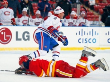 Montreal Canadiens' Russ Courtnall, right, skates away as Calgary Flames' Al MacInnis lies on the ice after falling during the seccond period of the NHL Heritage Classic alumni game in Calgary, Alta., Saturday, Feb. 19, 2011. THE CANADIAN PRESS/Jeff McIntosh