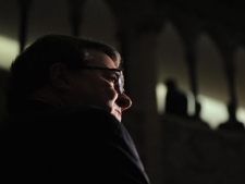 Finance Minister Jim Flaherty speaks to reporters in the foyer of the House of Commons on Parliament Hill in Ottawa on Thursday, September 22, 2011. (THE CANADIAN PRESS/Sean Kilpatrick)