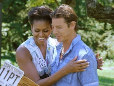In this image released by ABC, first lady Michelle Obama, left, embraces host Ty Pennington during a taping of a two-part premiere of the home makeover series, "Extreme Makeover: Home Edition," in Washington. As part of her Joining Forces initiative, Michelle Obama participated in the episode featuring the Marshalls, a military family based in Fayetteville, N.C. The premiere of "Extreme Makeover: Home Edition" airs Sunday, Sept. 25, 2011 on ABC. (AP Photo/ABC, Randy Sager) 
