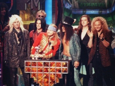 Guns N' Roses celebrate their Michael Jackson Video Vanguard Award for "November Rain" at the MTV Video Music ceremony Sept. 10, 1992 in Los Angeles. (AP Photo/Kevork Djansezian)
