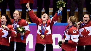 This Feb. 20, 2014 file photo shows members of Team Canada celebrating after defeating the United States during sudden death overtime women's hockey final action at the 2014 Sochi Winter Olympics in Sochi, Russia. (The Canadian Press, Nathan Denette)