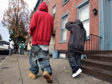 Two young men with low-slung, baggy jeans walk in Trenton, N.J., Saturday, Sept. 15, 2007. (AP Photo/Mel Evans)