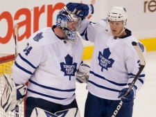 Toronto Maple Leafs netminder James Reimer is congratulated by teammate Carl Gunnarsson (right) following the final whistle as the Leafs defeated the Ottawa Senators 5-3 during NHL pre-season action in Ottawa, Tuesday September 27, 2011. (THE CANADIAN PRESS/Adrian Wyld)