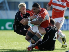 Japan's Sione Talikavili Vatuvei, is tackled by Canada's DTH van der Merwe, left, and Aaron Carpenter, right, during their Rugby World Cup game in Napier, New Zealand, Tuesday, Sept. 27, 2011. (AP Photo/Themba Hadebe)