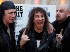 Steve Kudlow, centre, Robb Reiner, left, and Glenn Five, of the Canadian band Anvil, arrive at the premiere of "Anvil! The Story of Anvil" in Los Angeles on Tuesday, April 7, 2009. (AP Photo/Matt Sayles)