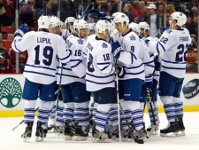 Toronto Maple Leaf players celebrate a victory after a game-winning goal by defenseman Mike Komisarek in overtime against the Detroit Red Wings an NHL preseason hockey game on Friday, Sept. 30, 2011, in Detroit. Toronto won 4-3. (AP Photo/Rick Osentoski)