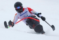 Josh Dueck of Canada races during the men's super combined slalom sitting event at the 2014 Winter Paralympics Tuesday, March 11, 2014, in Krasnaya Polyana, Russia. (AP Photo/Dmitry Lovetsky)