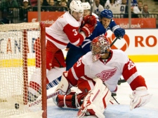 Toronto Maple Leafs' Joey Crabb (46) scores on Detroit Red Wings goaltender Ty Conklin as Red Wings' defenceman Garnet Exelby tries to hold him off duirng second period NHL pre-season action in Toronto on Saturday October 1, 2011. THE CANADIAN PRESS/Frank Gunn