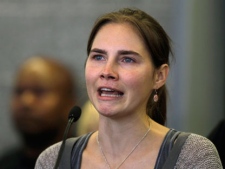 Amanda Knox looks up as she talks to reporters, Tuesday, Oct. 4, 2011, in Seattle. Knox was freed Monday after an Italian appeals court threw out her murder conviction for the death of her British roommate, Meredith Kercher. (AP Photo/Ted S. Warren)