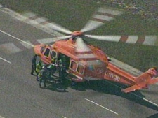 A patient is loaded into an air ambulance following a serious motorcycle accident on Highway 400. (CP24)