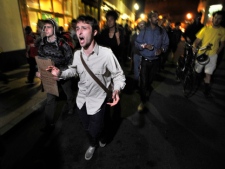 Demonstrators with "Occupy Boston" march toward the police station where fellow demonstrators were brought after police arrested people sleeping in an expansion of the Occupy Boston tent village in Boston, in the early morning hours of Tuesday, Oct. 11, 2011. (AP Photo/Josh Reynolds)