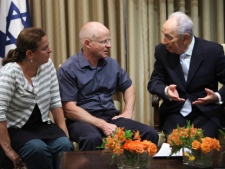Israeli President Shimon Peres, right, talks to Noam Schalit, center, and his wife Aviva, the parents of captured Israeli soldier Gilad Schalit, as Aviva looks on, at the President's residence in Jerusalem, Wednesday, Oct. 12, 2011. Israeli euphoria over a prisoner swap deal to free a soldier held by Hamas militants for five years gave way on Wednesday to a growing anxiety that the release of 1,000 Palestinian prisoners, some of them convicted of murder, could lead to a new round of violence.(AP Photo/Tara Todras-Whitehill, Pool)