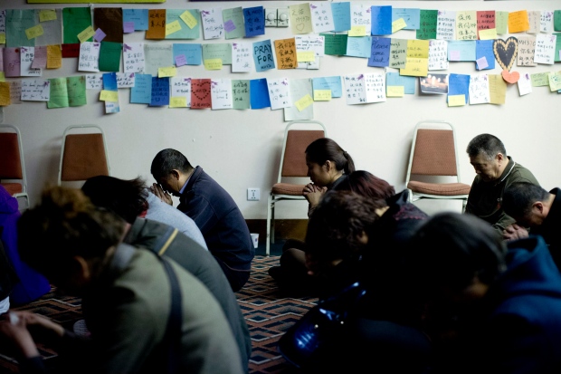Relatives of MH370 passengers pray for loved ones