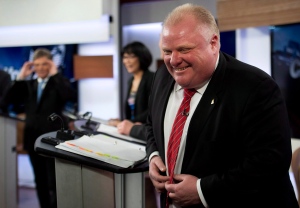 Mayor Rob Ford laughs during commercial break they he takes part in a live television mayoral debate in Toronto on Wednesday, March 26, 2014. (The Canadian Press/Nathan Denette)