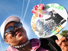 Janet Purnell, of D.C., holds up a sign as she attends the Martin Luther King, Jr. Memorial dedication in a ceremony hosted by the Washington, DC Martin Luther King, Jr. National Memorial Project Foundation in West Potomac Park, Sunday, Oct. 16, 2011. (AP Photo/The News Journal, Suchat Pederson)
