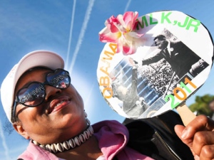 Janet Purnell, of D.C., holds up a sign as she attends the Martin Luther King, Jr. Memorial dedication in a ceremony hosted by the Washington, DC Martin Luther King, Jr. National Memorial Project Foundation in West Potomac Park, Sunday, Oct. 16, 2011. (AP Photo/The News Journal, Suchat Pederson)