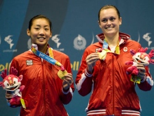 Canadian double's pair Alex Bruce, right, and Michelle Li, left, show off their gold medals after defeating the United States doubles Badminton during the 2011 Pan American Games in Guadalajara, Mexico on Wednesday, Oct. 19, 2011. (THE CANADIAN PRESS/Nathan Denette)