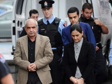 Tooba Mohammad Yahya and husband Mohammad Shafia and their son Hamed Mohammed Shafia are escorted by police officers into the Frontenac County Court courthouse on the first day of trial in Kingston, Ontario on Thursday, October 20, 2011. They are charged with four counts of first-degree murder in the deaths of Shafia's daughters Zainab, 19, Sahar, 17, Geeti Shafia,13, and Rona Amir Mohammad, 50, who were found dead inside a submerged car in the Rideau Canal in June of 2009. (THE CANADIAN PRESS/Sean Kilpatrick)