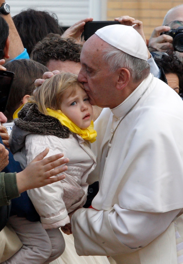 Pope Francis kisses child ahead of Easter