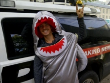 A man dressed in a shark costume gestures during a demonstration outside city hall Tuesday, Oct. 25, 2011. Supporters of a proposed shark fin ban gathered outside city hall ahead of a vote on the proposal. (CP24/George Lagogianes)