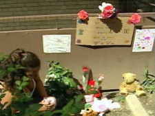 Neighbours and family members have left flowers and teddy bears outside the apartment where seven-year-old Katelynn Sampson was found dead on Sunday, August 3.