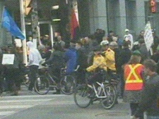 Protesters with the 'Occupy Toronto' movement are seen marching to the city's financial district Saturday afternoon. (CP24)