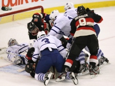 Toronto Maple Leafs goaltender Jonas Gustavsson lies back in his net as Ottawa Senators and Maple Leafs players battle for the puck during an NHL game in Ottawa, Sunday Oct. 30, 2011. (THE CANADIAN PRESS/Fred Chartrand)