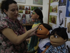 In a Thursday, Oct. 13, 2011 photo, a Pakistani artist gives final touches to characters of Pakistani Sesame Street in Lahore, Pakistan. Sesame Street is coming to Pakistan, but not as generations of Americans know it. The U.S. is bankrolling the initiative with $20 million, hoping it will improve education in a country where one-third of primary school age children are not in school. Washington also hopes the program will increase tolerance at a time when Pakistan is wracked by a Taliban insurgency and the influence of radical views is growing. (AP Photo/K.M.Chaudary)