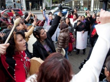 Women sing and chant outside of the missing women inquiry in downtown Vancouver, Tuesday, Oct. 11, 2011. Commissioner Wally Oppal has opened hearings to examine why police failed to stop Pickton as he murdered impoverished sex workers from Vancouver's Downtown Eastside. THE CANADIAN PRESS/Jonathan Hayward