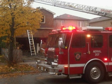 A fire truck is parked outside a Brampton home Monday, Nov. 8, 2011, after a fire the night before. Firefighters found a marijuana grow op in the home. (CP24/Cam Woolley)