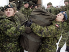 Female members of the Canadian Forces DART (Disaster Assistance Response Team) unload their kits from trucks in Trenton, Ont., Thursday, Jan. 6, 2005 before being deployed to Sri Lanka. (CP PHOTO/Tom Hanson)