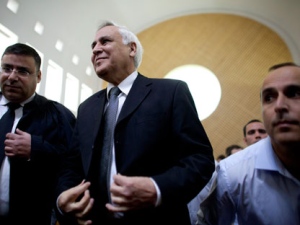 Former Israeli President Moshe Katsav, center, pauses at the Supreme court in Jerusalem, Thursday, Nov. 10, 2011. Israel's Supreme Court on Thursday ordered former President Moshe Katsav to spend seven years in prison after rejecting the disgraced politician's appeal of a rape conviction and other sex crimes. (AP Photo/Uriel Sinai)