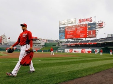 Washington Nationals pitcher Cole Kimball walks on the field for baseball practice at Nationals Park on Wednesday, March 30, 2011, in Washington. The Nationals' home-opener is scheduled for Thursday against the Atlanta Braves. (AP Photo/Alex Brandon)