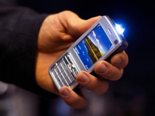 Toronto police display a stun gun disguised as a cellphone Wednesday, Nov. 16, 2011. Police seized about 100 of the stun guns, in addition to other restricted weapons, after Canada Border Services Agency officers seized a shipment. (THE CANADIAN PRESS/Nathan Denette)