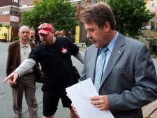 Peter Stoffer, the NDP veterans affairs critic, is accompanied by veteran Dennis Manuge, left, in Halifax on Friday, Aug. 5, 2011. (THE CANADIAN PRESS/Andrew Vaughan)