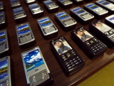 Toronto police display a stun gun disguised as a cellphone Wednesday, Nov. 16, 2011. Police seized about 100 of the stun guns, in addition to other restricted weapons, after Canada Border Services Agency officers seized a shipment. (THE CANADIAN PRESS/Nathan Denette)