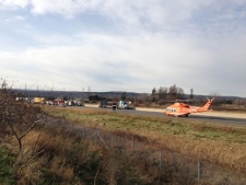 An air ambulance sits on Highway 401 in Milton following a collision involving a car and a tractor-trailer on Friday Nov. 18, 2011. 