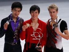 Patrick Chan of Canada, center , with gold medal poses with silver medallist Song Nan of China, left, and bronze medallist Michal Brezina of Czech Republic, right, on the podium of the Men during the Ice Skating Bompard Trophy at Bercy arena in Paris, Saturday, Nov. 19, 2011. (AP Photo/Francois Mori)