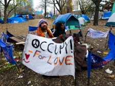Occupy Toronto protesters hold their ground and space after sleeping outside in St. James Park in Toronto on Monday, Nov. 21, 2011. (Nathan Denette / THE CANADIAN PRESS)