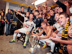 Los Angeles Galaxy midfielder David Beckham, bottom left, celebrates with his teammates after the Galaxy defeated the Houston Dynamo in the MLS Cup championship soccer match, Sunday, Nov. 20, 2011, in Carson, Calif. (AP Photo/Bret Hartman)