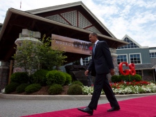 U.S. President Barack Obama walks away after being greeted by Canadian Prime Minister Stephen Harper during the official welcoming of the G8 leaders to the G8 Summit in Huntsville, Ont., on Friday, June 25, 2010. (THE CANADIAN PRESS/Sean Kilpatrick)