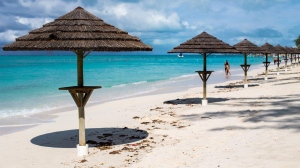 Beachside umbrellas are seen on the coast of Turks and Caicos (Turks and Caicos Tourism).